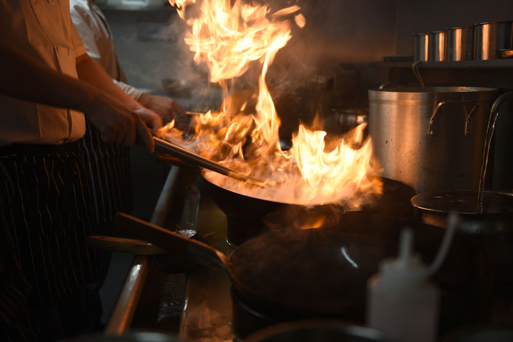 Chefs cooking on woks at 1423 China Kitchen